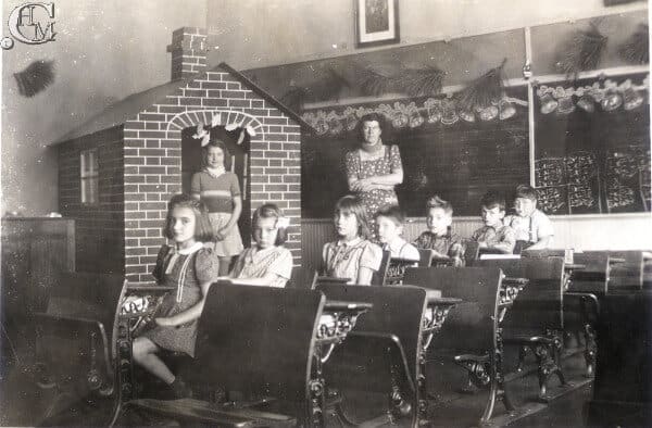 Students sit at desk inside a classroom