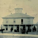 Marshall hotel, men standing on porch, men on horseback